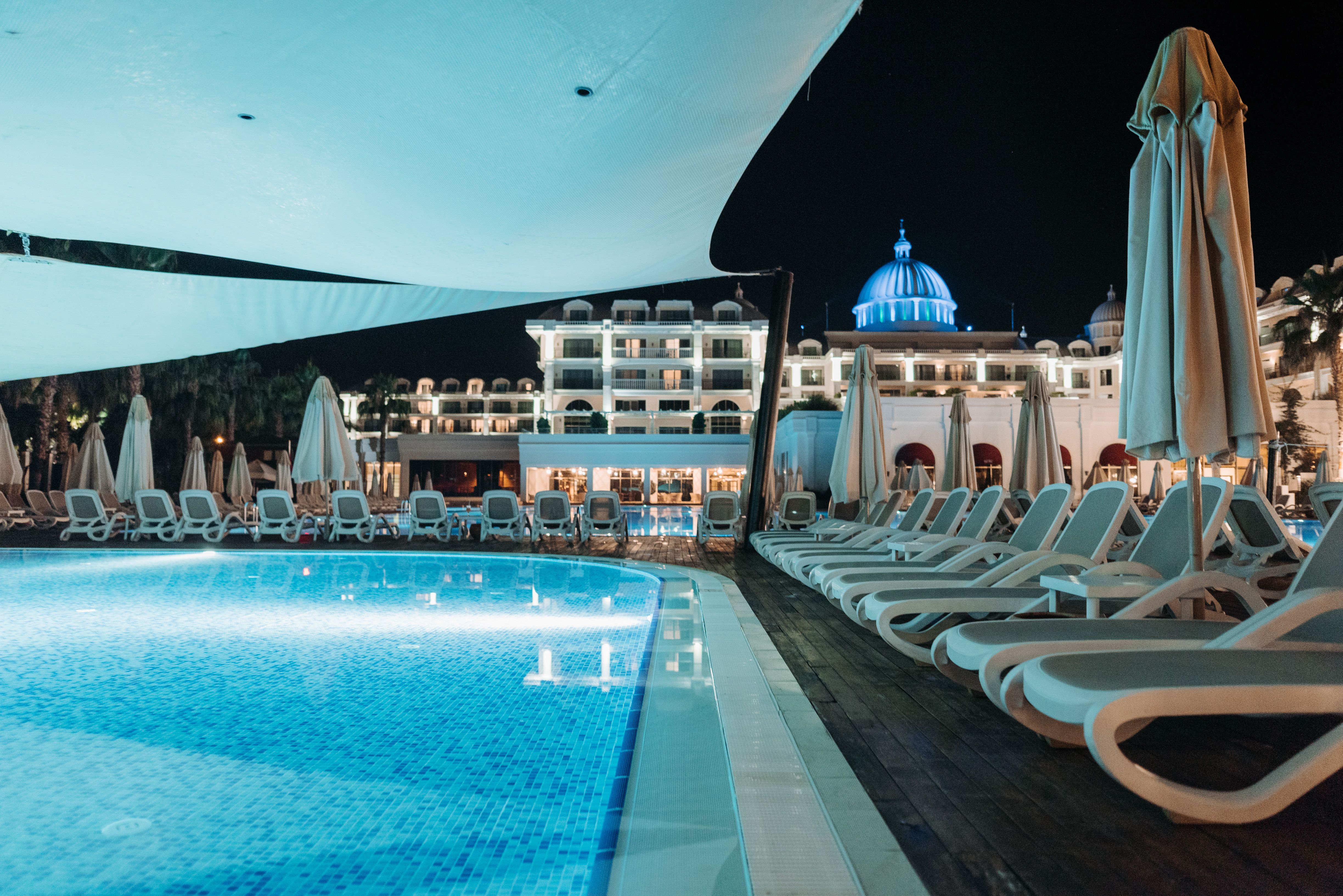 Luxury poolside lounge with atmospheric lighting at night