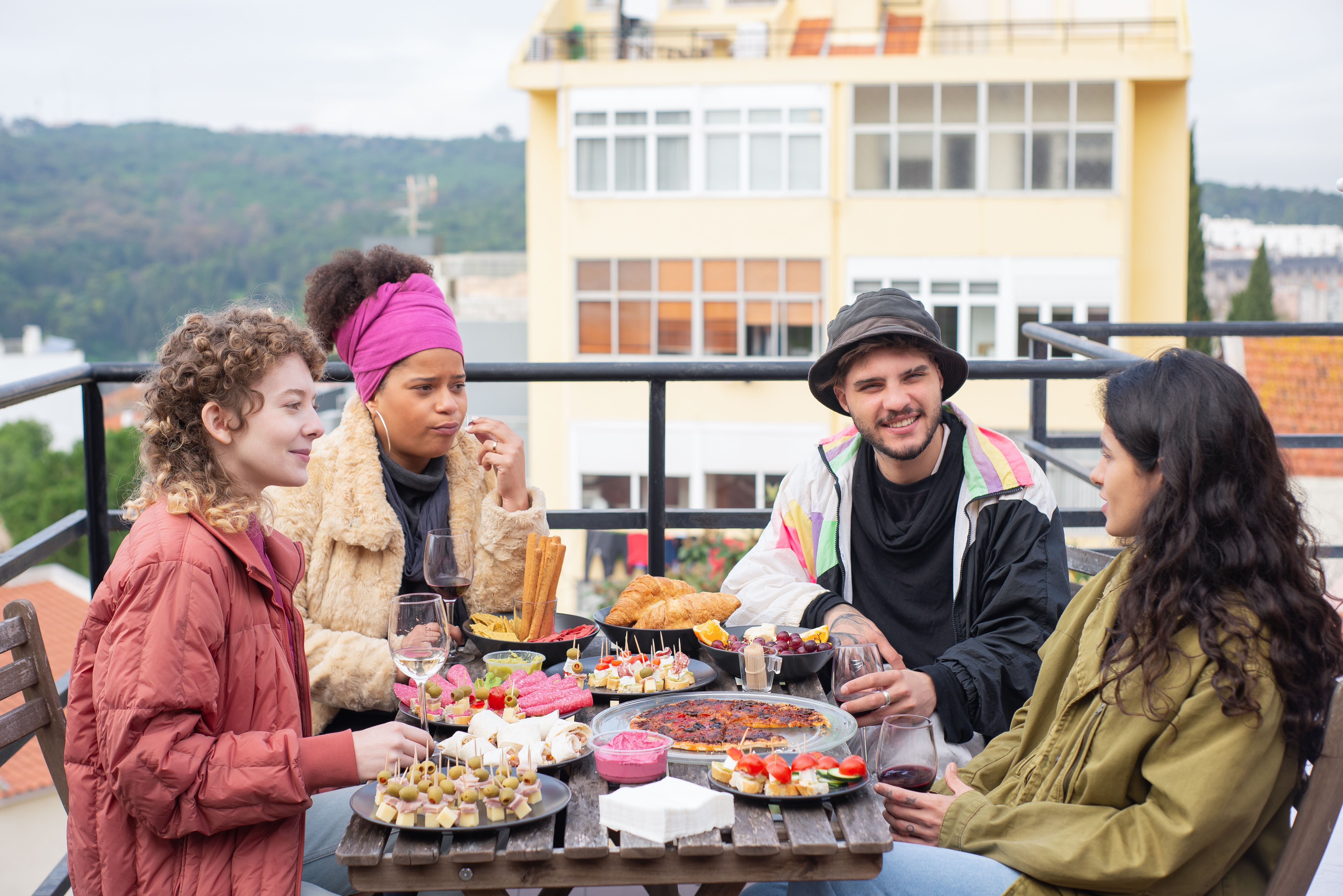 Friends enjoying a meal together on a stylish outdoor terrace
